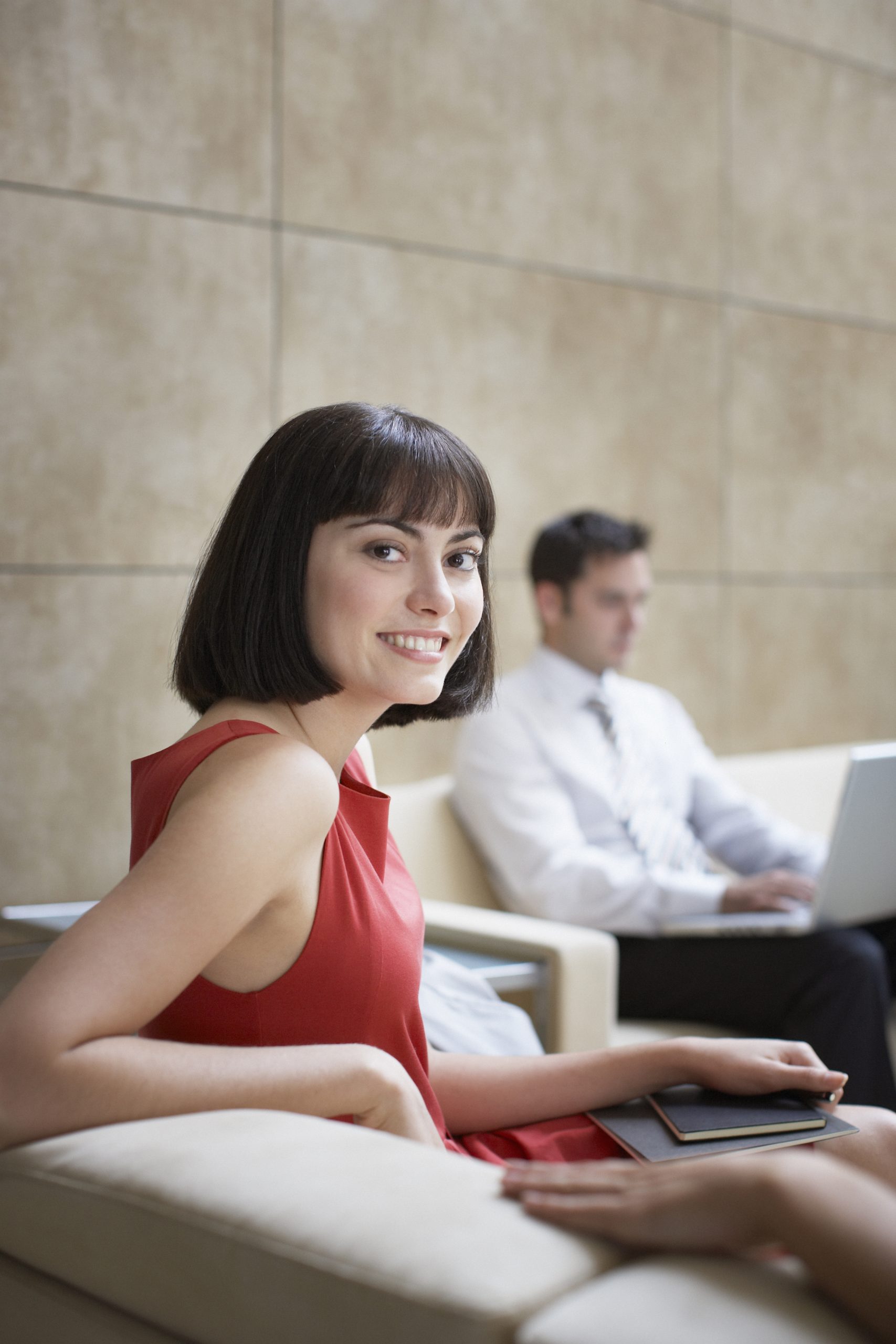Businesswoman sitting in office lobby
